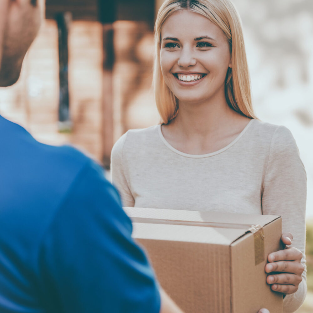From,Hands,To,Hands,Delivery.,Beautiful,Young,Woman,Smiling,While